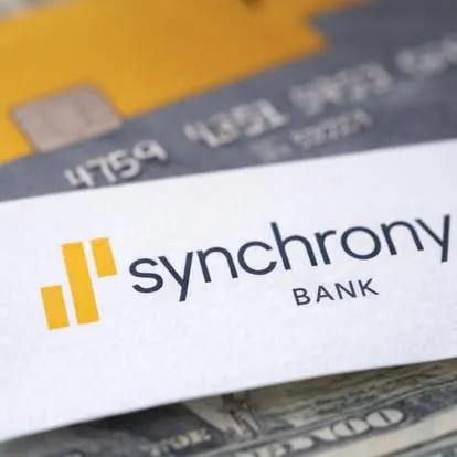 Financing through Synchrony Synchrony Bank card resting on a credit card and cash; financing is available through the Synchrony project card at Advantage HVAC, Plumbing and Electrical
