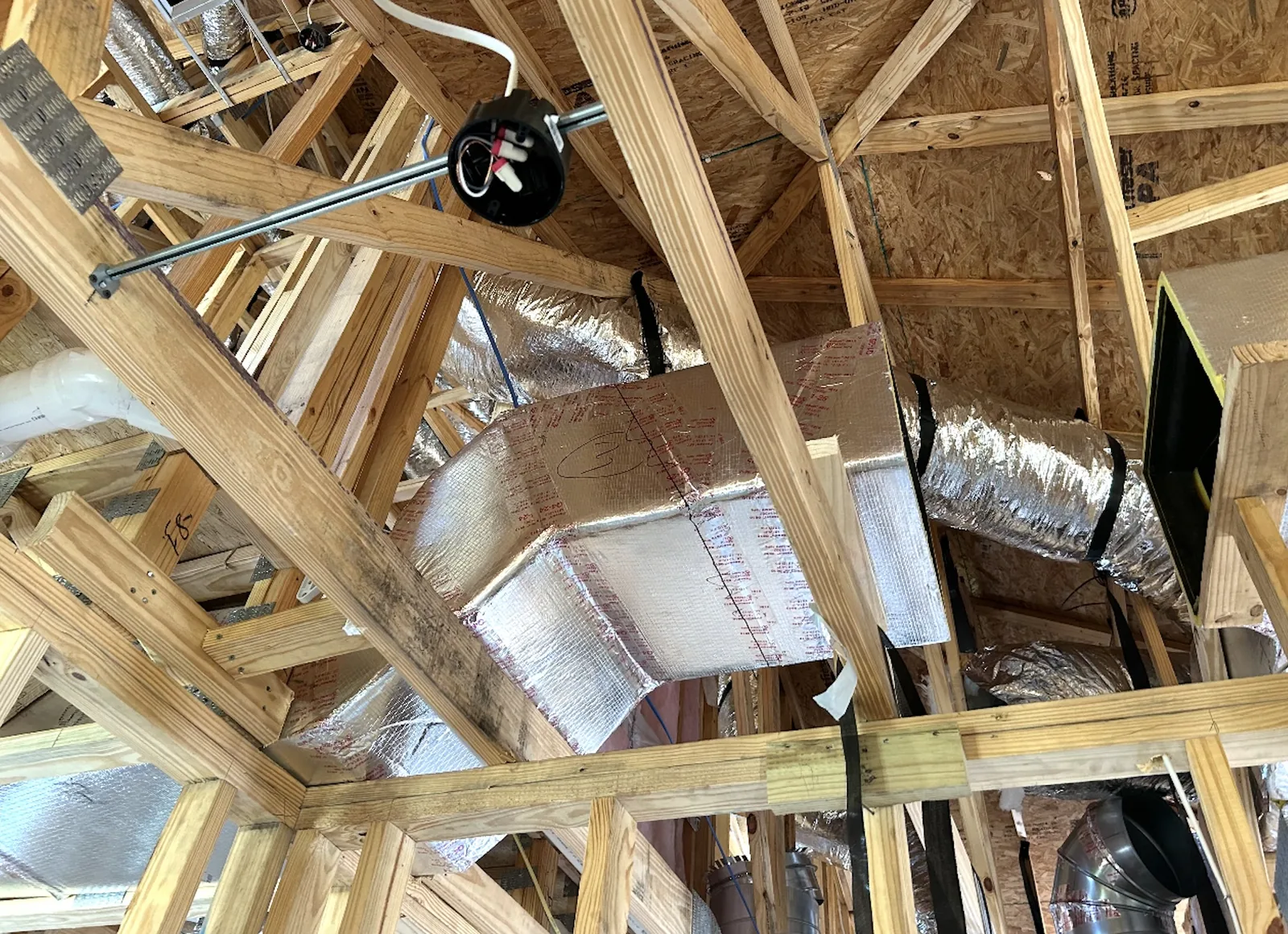 Ductwork Repair New insulated ductwork and supply plenum run through the roof trusses of an Emerald Coast home during a ductwork replacement